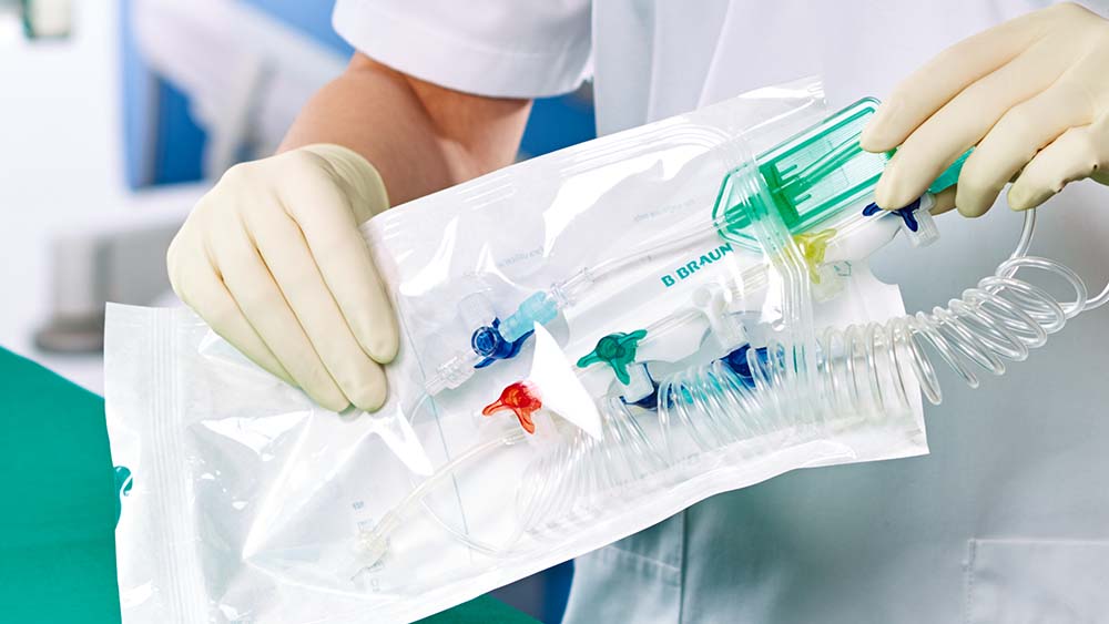 A healthcare professional is shown removing a B. Braun pre-set medical instrument from its sterile bags.