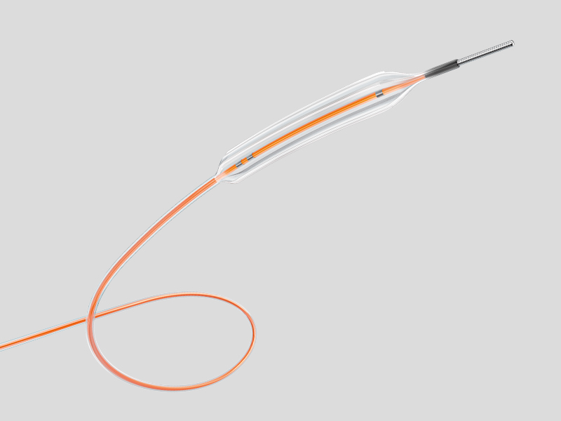 A medical device labeled Aperta NSA PTA, shown as a long, thin catheter with an orange flexible guidewire loop at one end and a narrow metallic tip at the other, displayed on a neutral gray background.